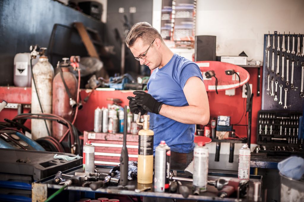 car mechanic working in auto vulcanizing and vehicle service workshop